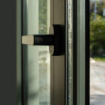 Aluminum door detail. Metal window frame open closeup view. Energy efficient, safety profile, blur outdoor background